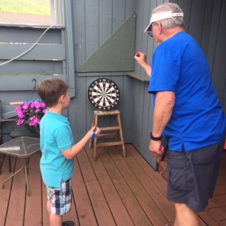 Life skills like darts with Pop Pop...